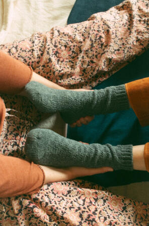 A participant holds her partners feet softly. Tekie Quaye Studio